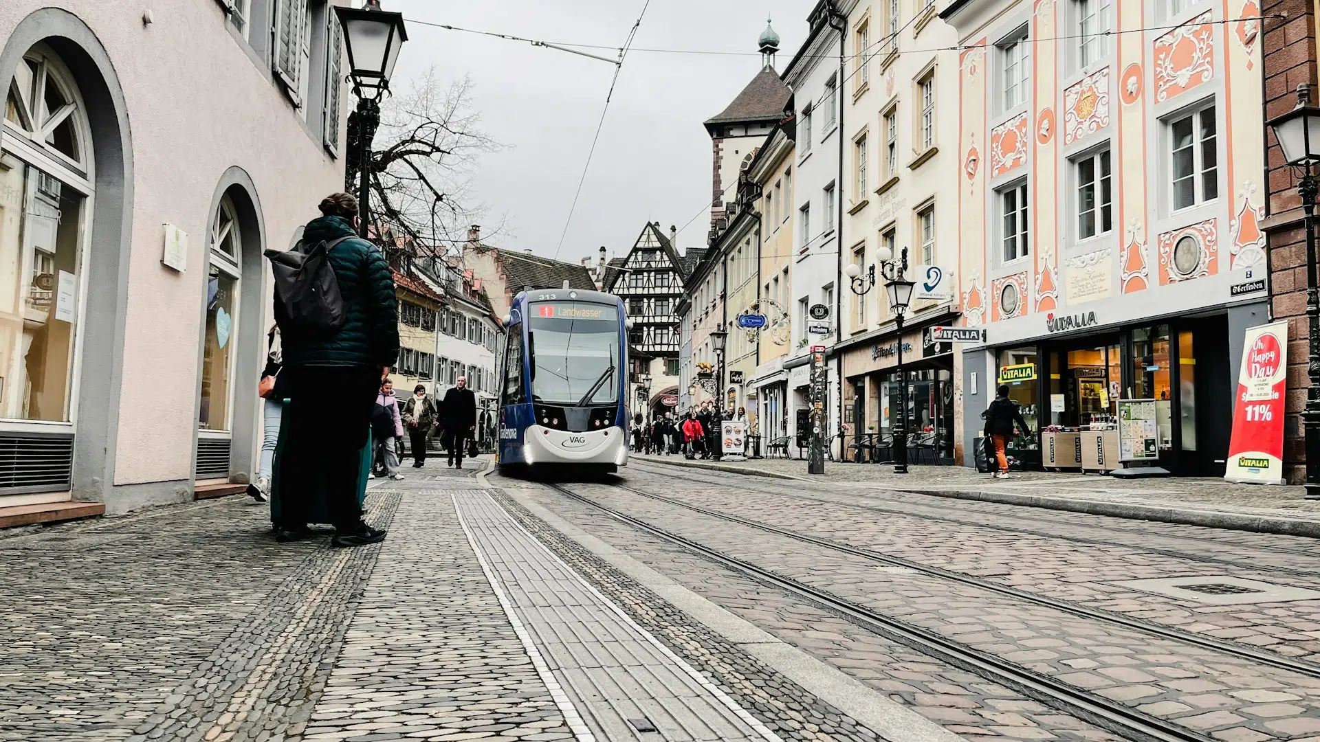 Freiburg Fußgängerzone mit Menschen und Straßenbahn